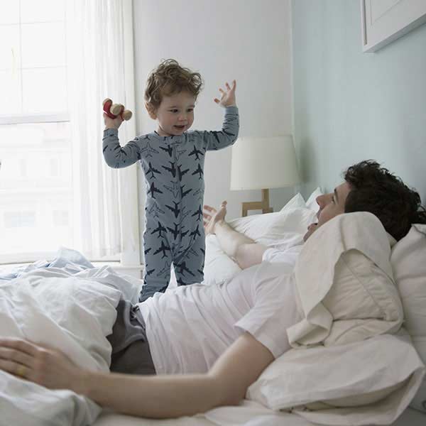 Little boy waking up his dad