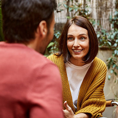 smiling woman talking with man